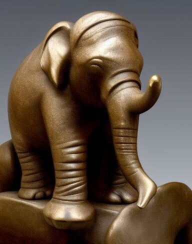 Bronze elephant and a rock statue