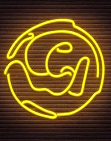 Yellow flower neon sign on a brick wall