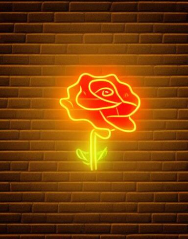 A yellow flower neon sign on a brick wall