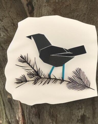 A paper cut of a bird in the forest