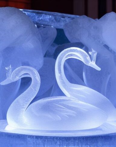 An tranquil ice sculpture of two sparkling ice-made swans on a wave
