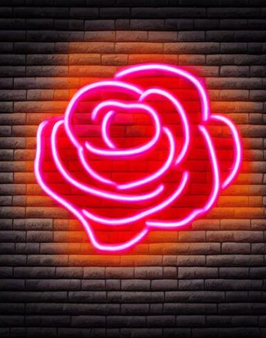A flower neon sign on a brick wall