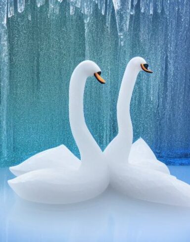 An tranquil ice sculpture of two sparkling ice-made swans on a wave