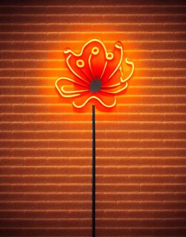 A orange flower neon sign on a brick wall