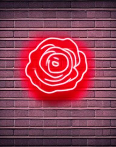 A tiny flower neon sign on a brick wall