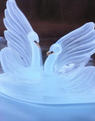 An tranquil ice sculpture of two flowing ice-made swans on a wave