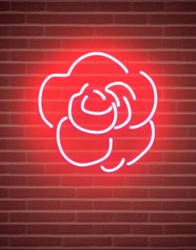 A simple flower neon sign on a brick wall
