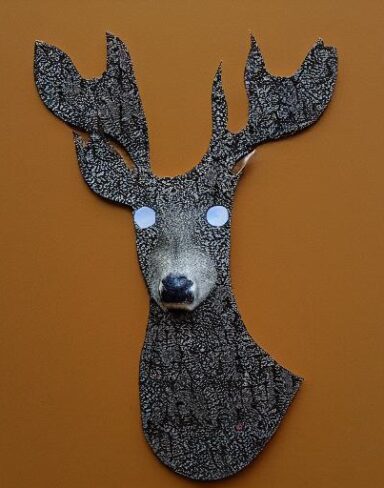 Paper cut of a deer in a forest