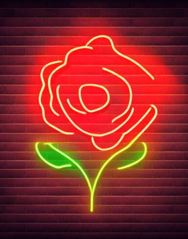 A small flower neon sign on a brick wall