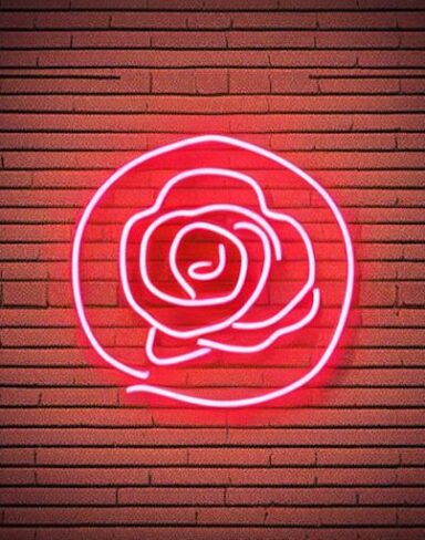 A one line flower neon sign on a brick wall