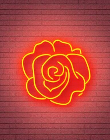 A flower neon sign on a brick wall
