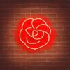 A red flower neon sign on a brick wall A red flower neon sign on a brick wall