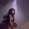 A woman standing inside a cave A woman standing inside a cave